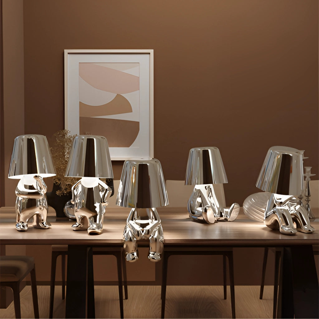 A stylish thinker lamp placed on a wooden desk with a serene ambiance, ideal for nightstand or desk lighting. The setting includes modern interior design elements and furniture.