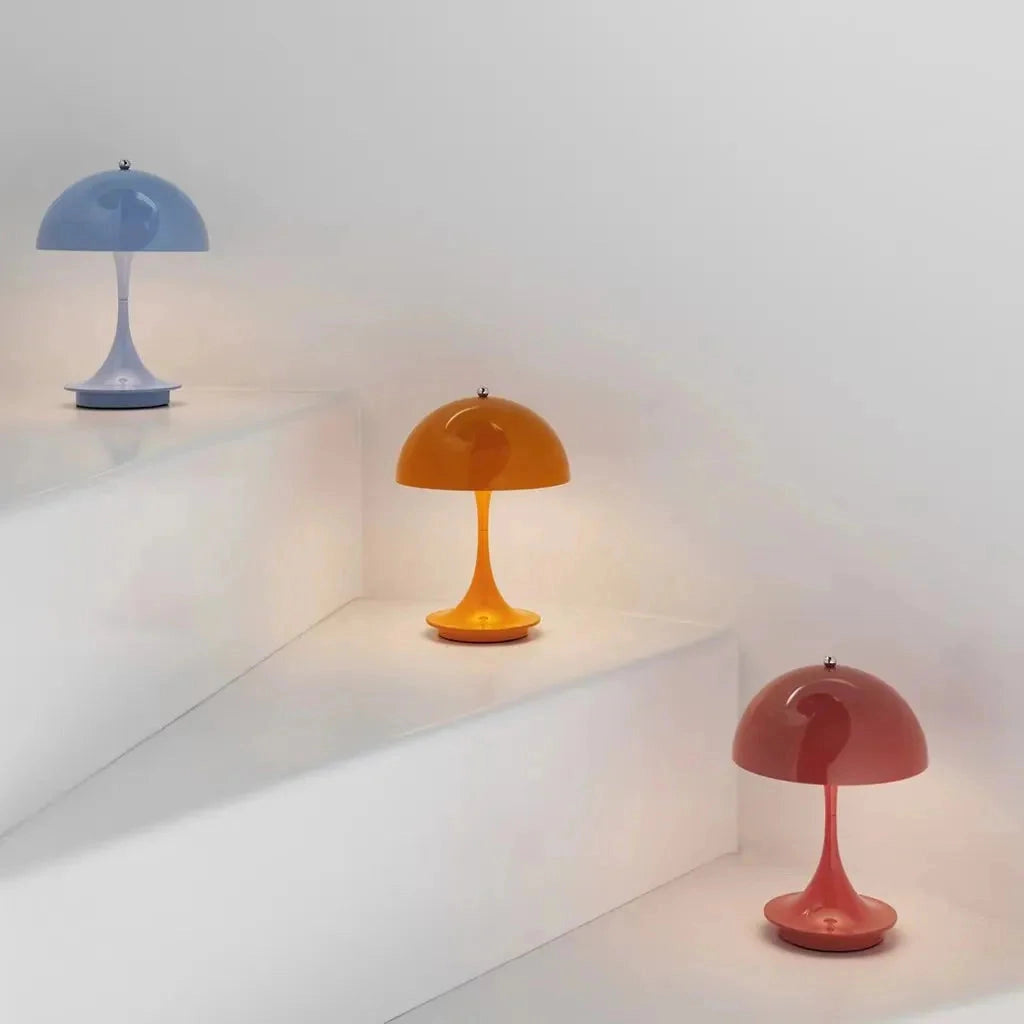 Gray Table Lamp Louis Poulsen Panthella 160 Portable placed on a wooden shelf against a neutral wall.