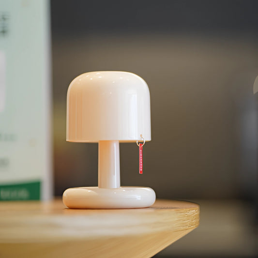 Ivory table lamp with touch switch and dimmable feature, featuring a wooden base and sleek design, showcased in still life photography.