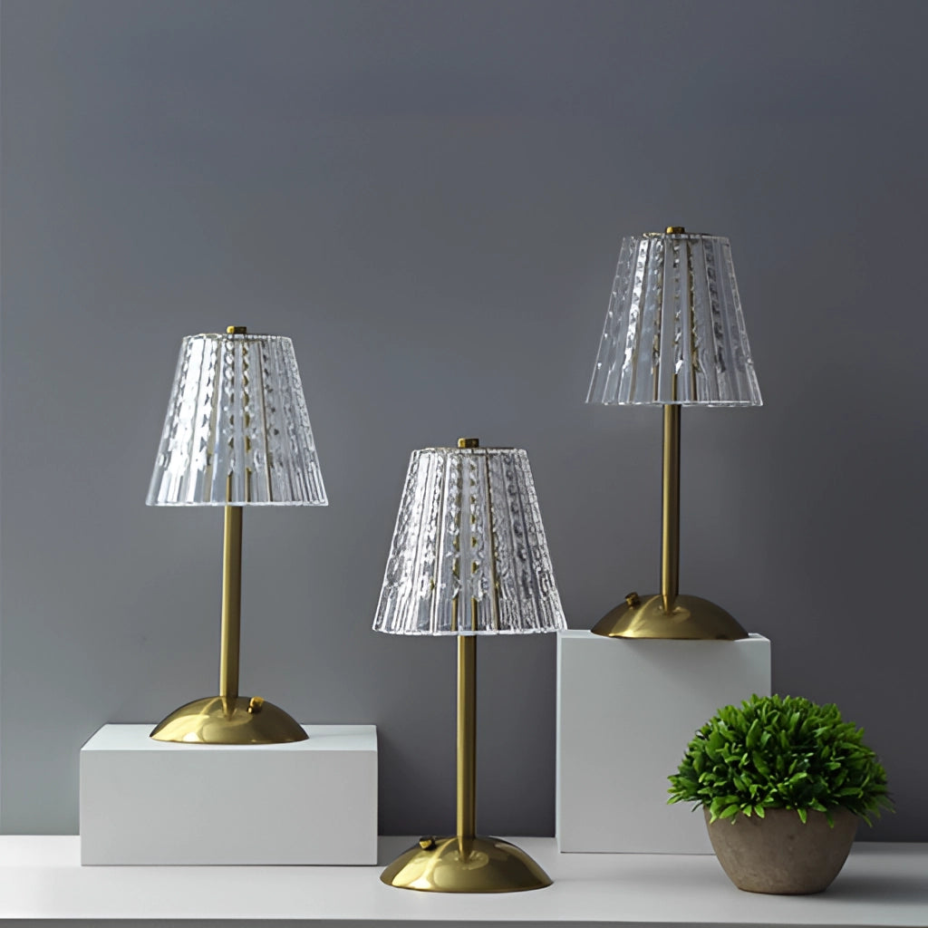 Cordless tricolor dimmable LED table lamp with wooden base, placed on a table next to a potted plant, in a modern interior setting.
