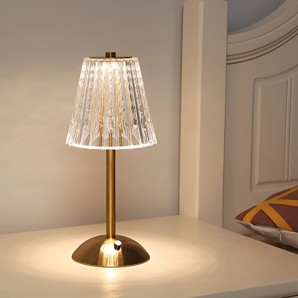 A tricolor dimmable cordless LED table lamp with a wooden base and metal accents, featuring a sleek lampshade, positioned next to a plant in a modern, artistic setting.