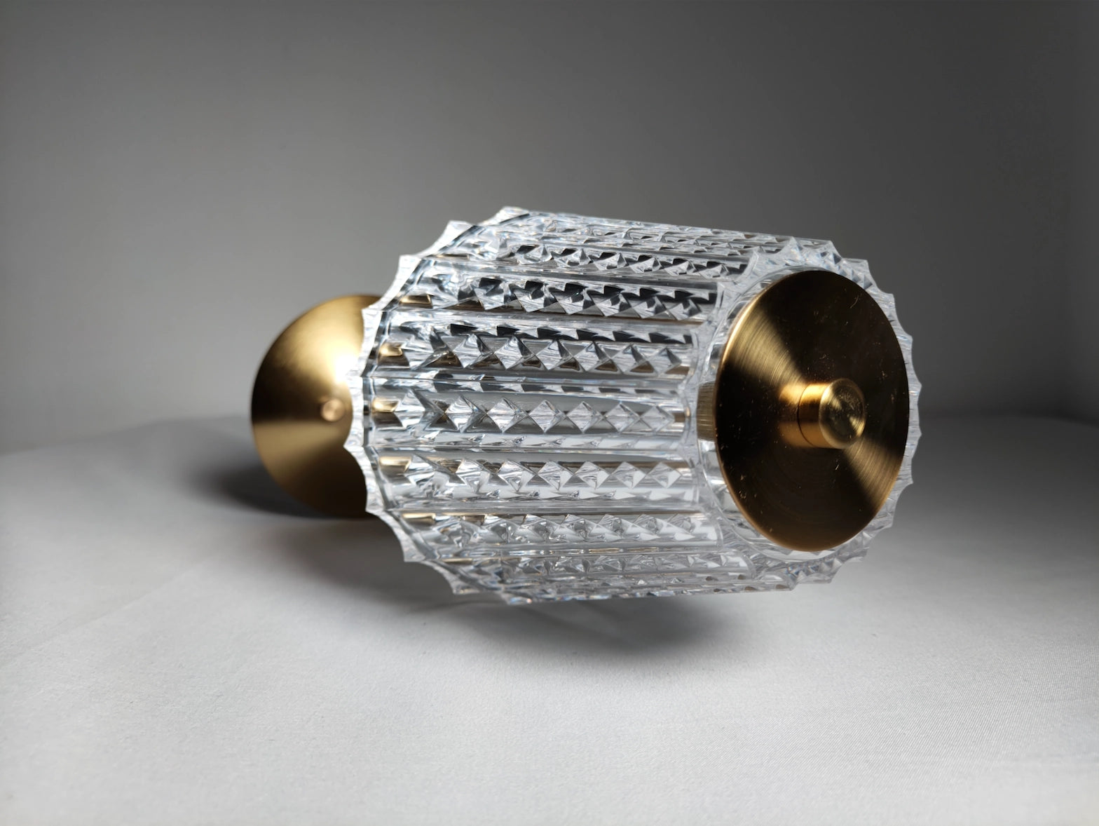 Cordless LED table lamp with tricolor dimmable feature, cylindrical metal body, amber light, and sleek modern design.