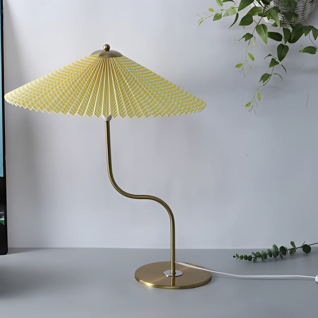 Table lamp with an umbrella-shaped shade featuring a yellow diamond pattern, khaki and white flowers, and dark green accents. The lamp has a wooden base.