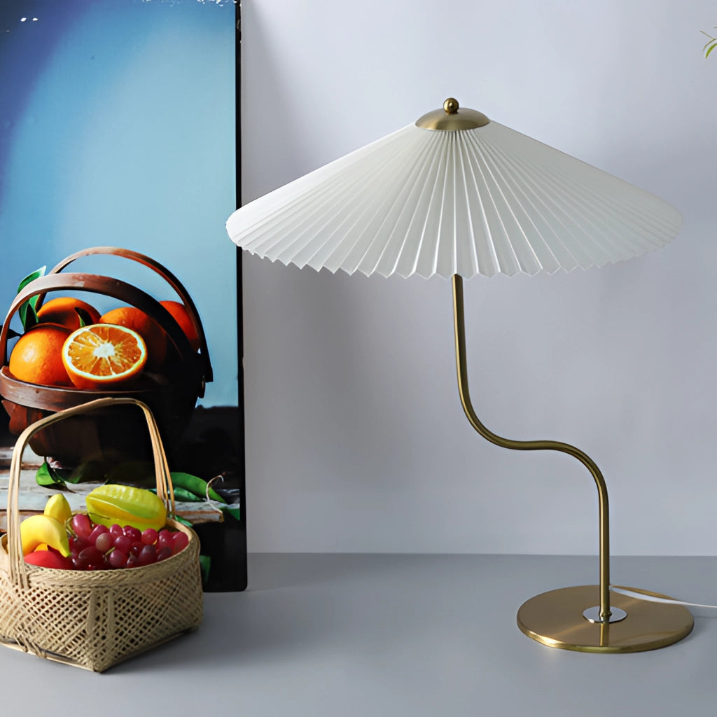 A white table lamp with an umbrella-shaped shade featuring a yellow diamond pattern and floral designs, set against a khaki and dark green background.