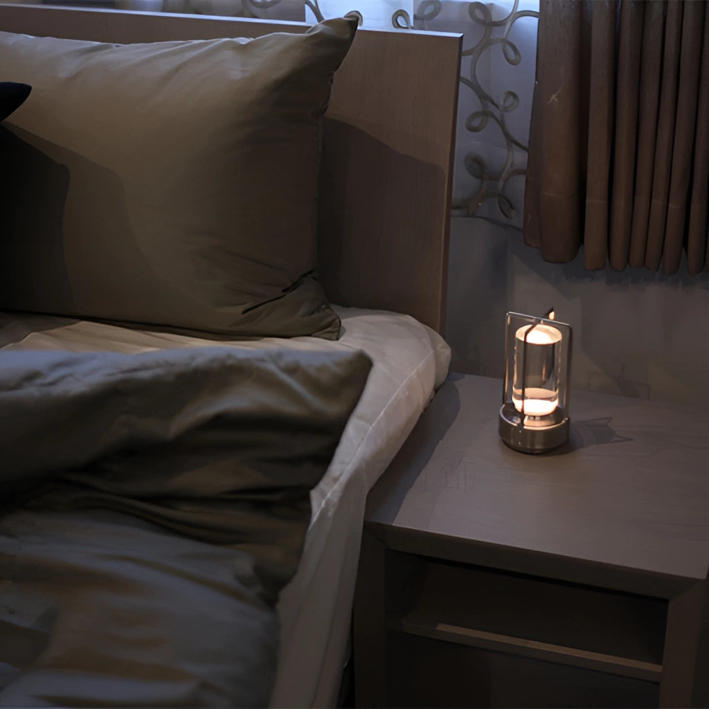 A wooden table lamp with a dimming feature, showcased on a grey hardwood table, surrounded by stylish interior design elements including a pillow and tableware.