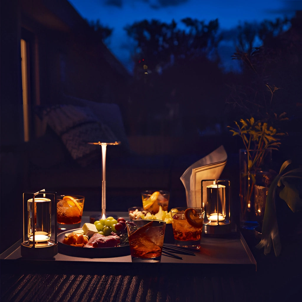 A stylish table lamp with a dimming feature, placed on a wooden table near a window with a view of trees and sky.