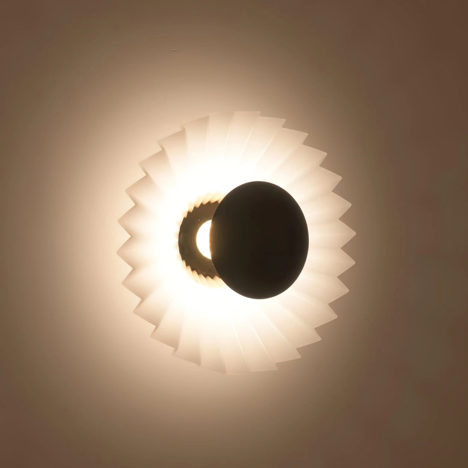 Modern wall lamp featuring artistic elegance, premium materials, and circular design, illuminating with a warm glow.