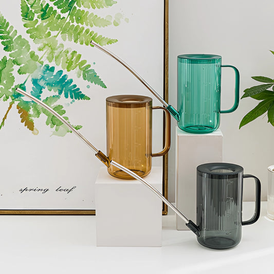 A sleek watering can with an extended spout, designed for accurate water delivery, placed near potted plants and wooden decor.