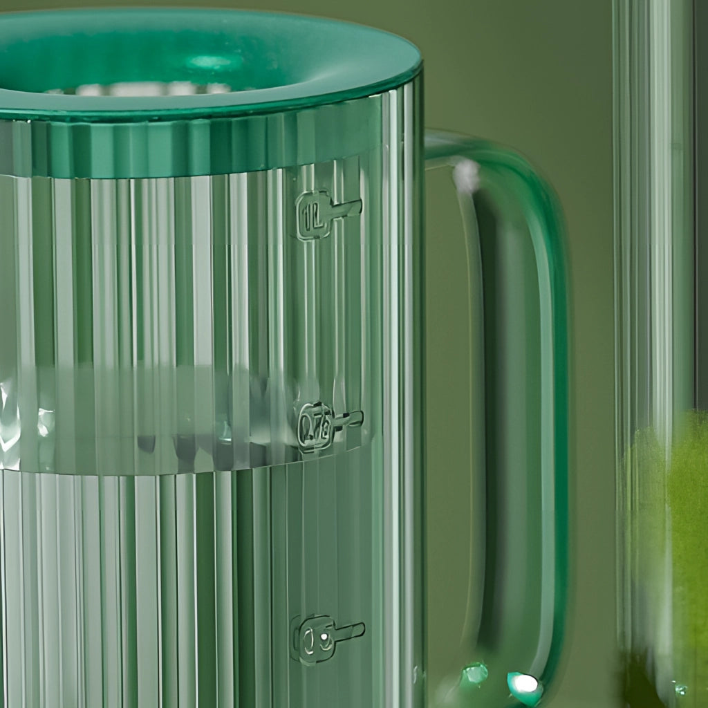 A green watering can with an extended spout designed for accurate water delivery, shown on a light background.