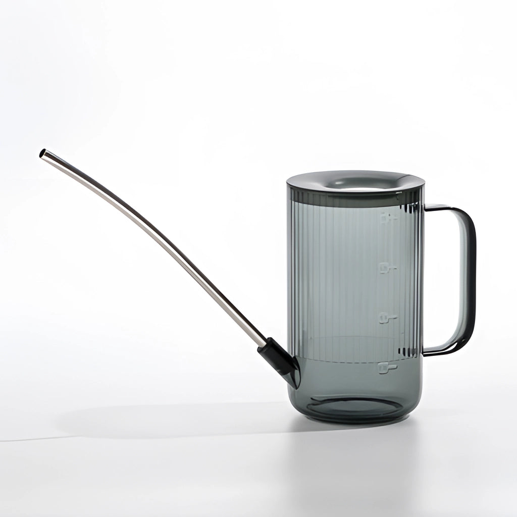 Gray Watering Can with Extended Spout for Accurate Water Delivery on a table.