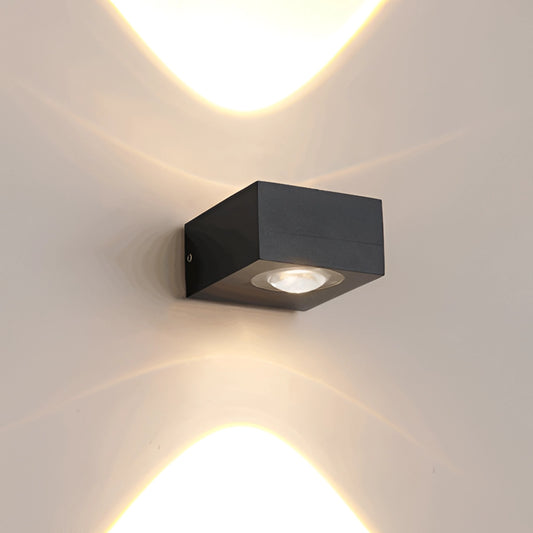 Waterproof black UFO-shaped wall light mounted on a wooden surface, showcasing its sleek metal and composite material design.