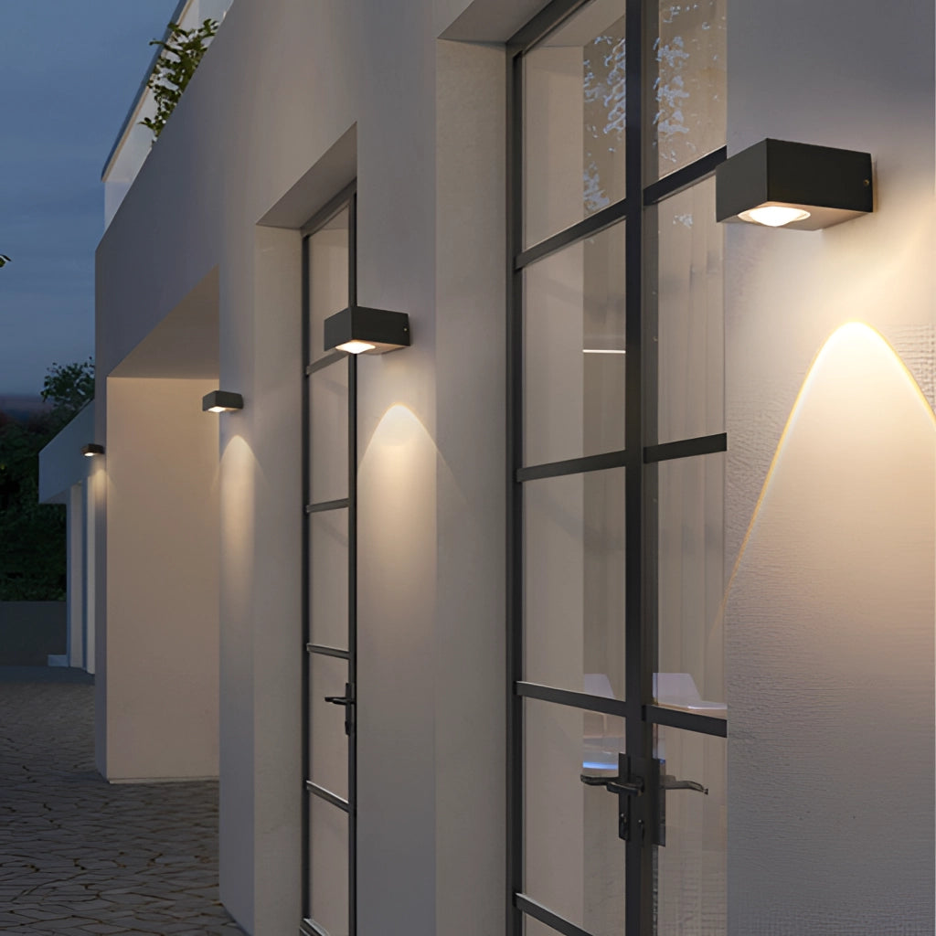 Waterproof black UFO wall light installed on an exterior building facade with modern design elements.