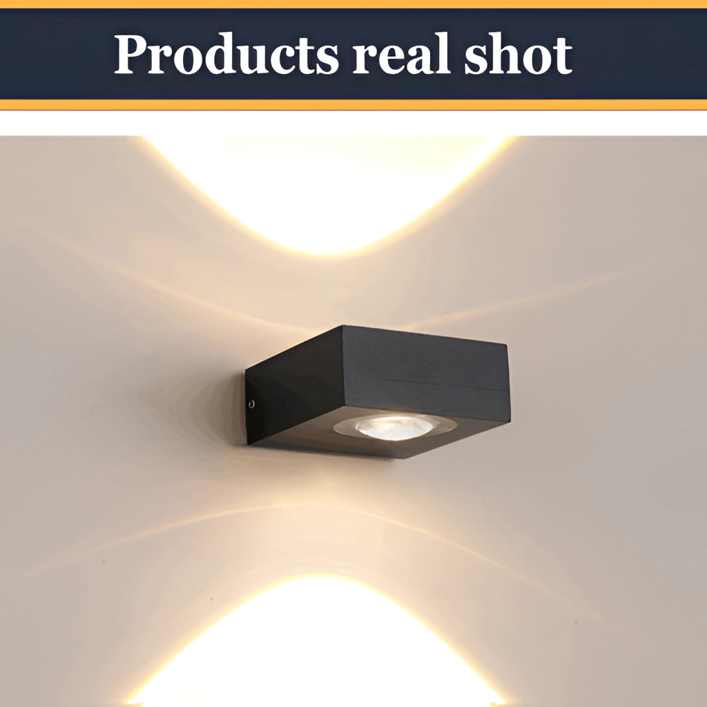 Waterproof black UFO wall light emitting a yellow glow with a rectangular fixture.