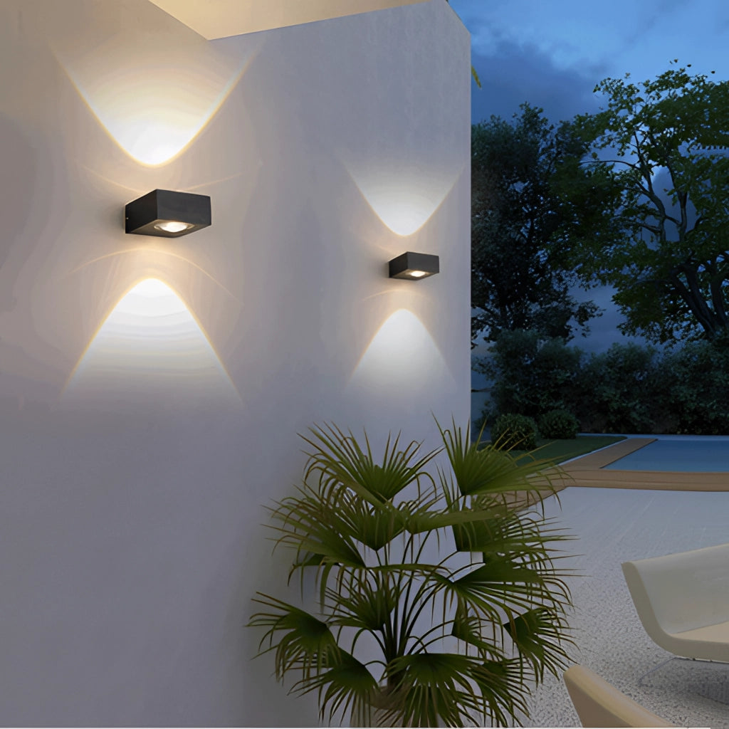 Waterproof black UFO wall light illuminating a modern interior space with plants and wooden elements.