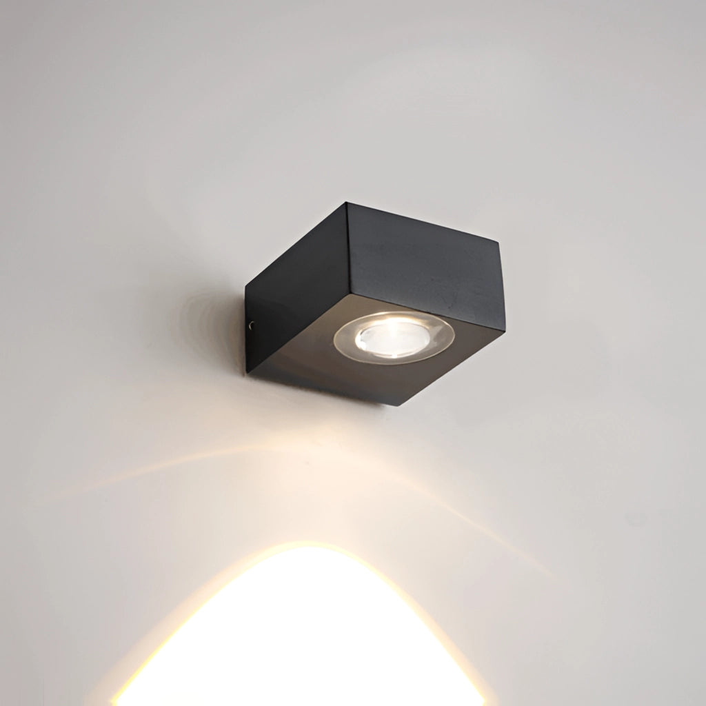 Waterproof black UFO wall light mounted on a wooden rectangular surface, featuring a circular design and metallic finish.