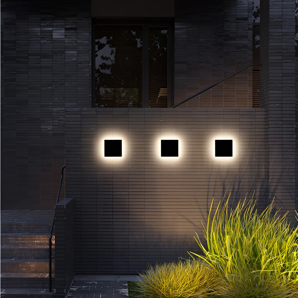 Waterproof LED outdoor wall lamp aluminum light fixture mounted on a brick wall near a window with surrounding plants and grass.