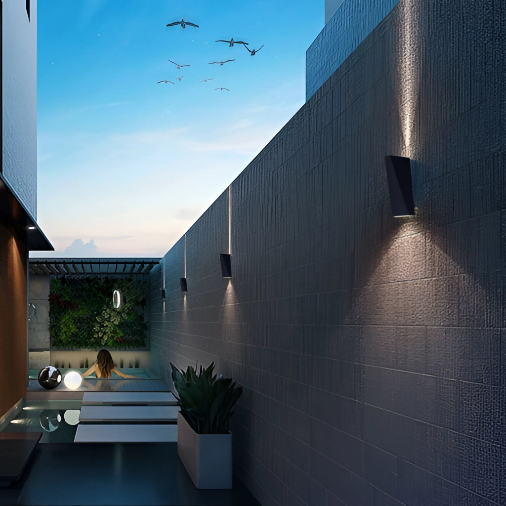 Modern Nordic style waterproof LED outdoor wall light mounted on a building facade under a cloudy sky with surrounding plants and urban architecture.