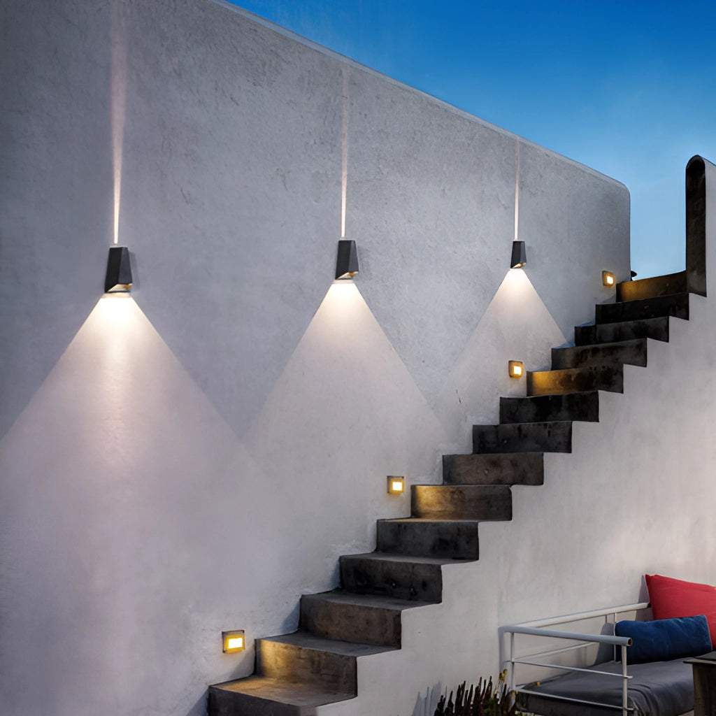 Waterproof Outdoor Pyramid LED Wall Sconce mounted on a modern exterior wall with wooden elements and stairs in the background.