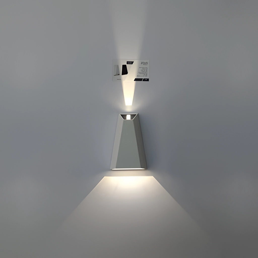 Waterproof outdoor pyramid LED wall sconce with a white body, emitting warm white light.
