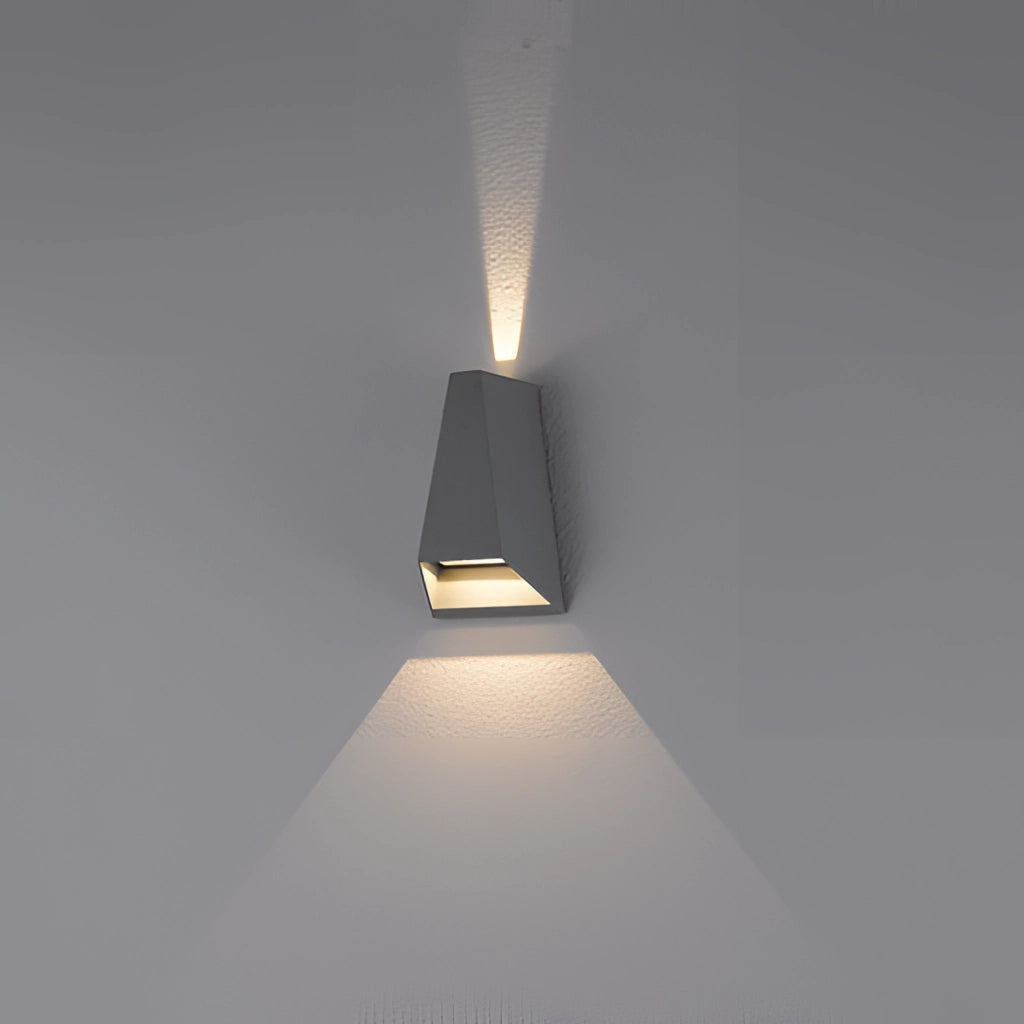 Waterproof Outdoor Pyramid LED Wall Sconce mounted on a wooden wall, emitting light and casting shadows.