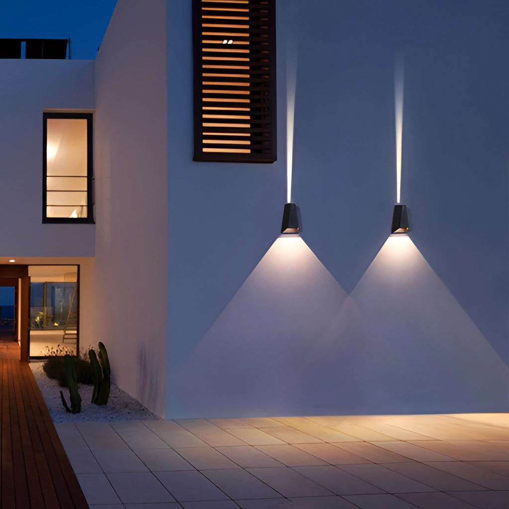Waterproof Outdoor Pyramid LED Wall Sconce mounted on an exterior wooden wall next to a window.