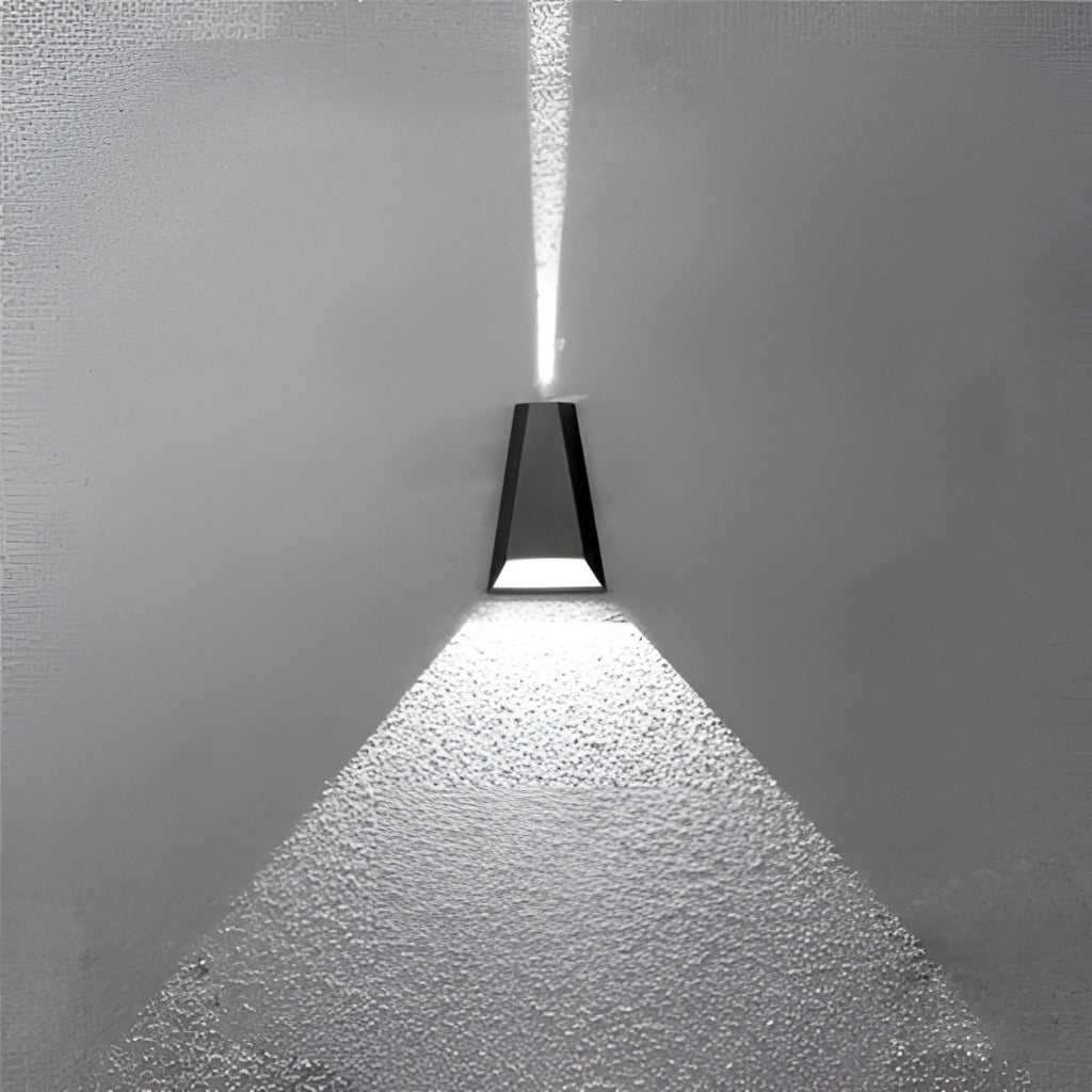 Waterproof outdoor pyramid LED wall sconce mounted on a dark wooden wall, illuminating the area with a symmetrical, monochromatic light.