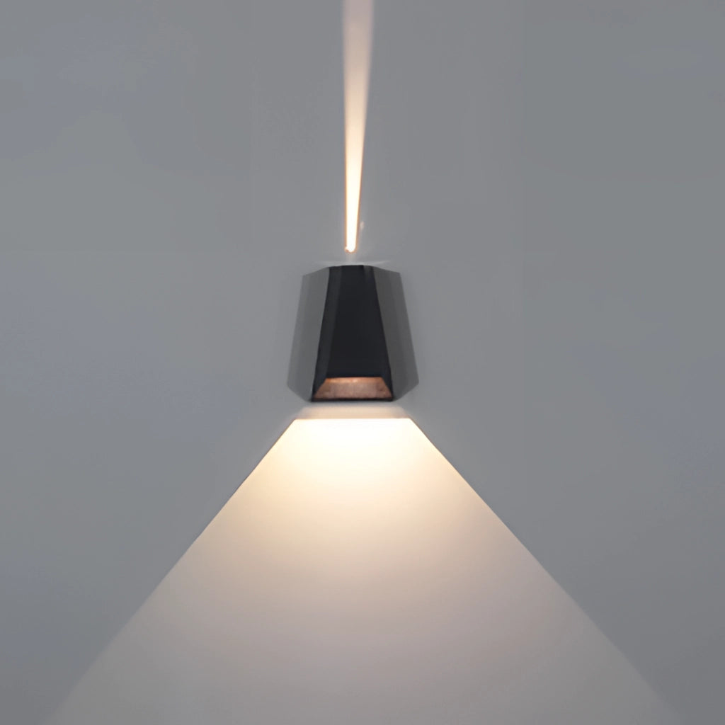 Waterproof Outdoor Pyramid LED Wall Sconce mounted on a wooden surface, emitting warm light.