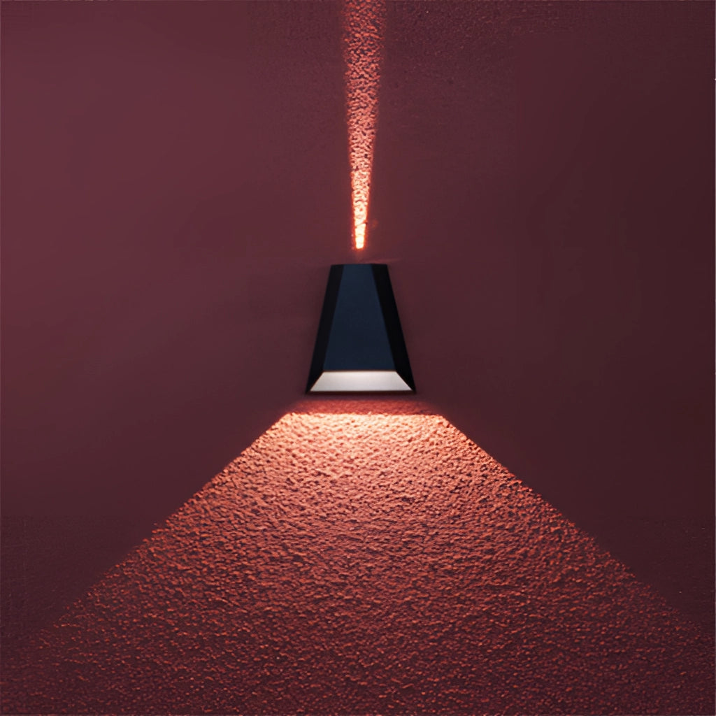 Waterproof Outdoor Pyramid LED Wall Sconce mounted on a wooden wall, emitting a warm light with symmetrical design.