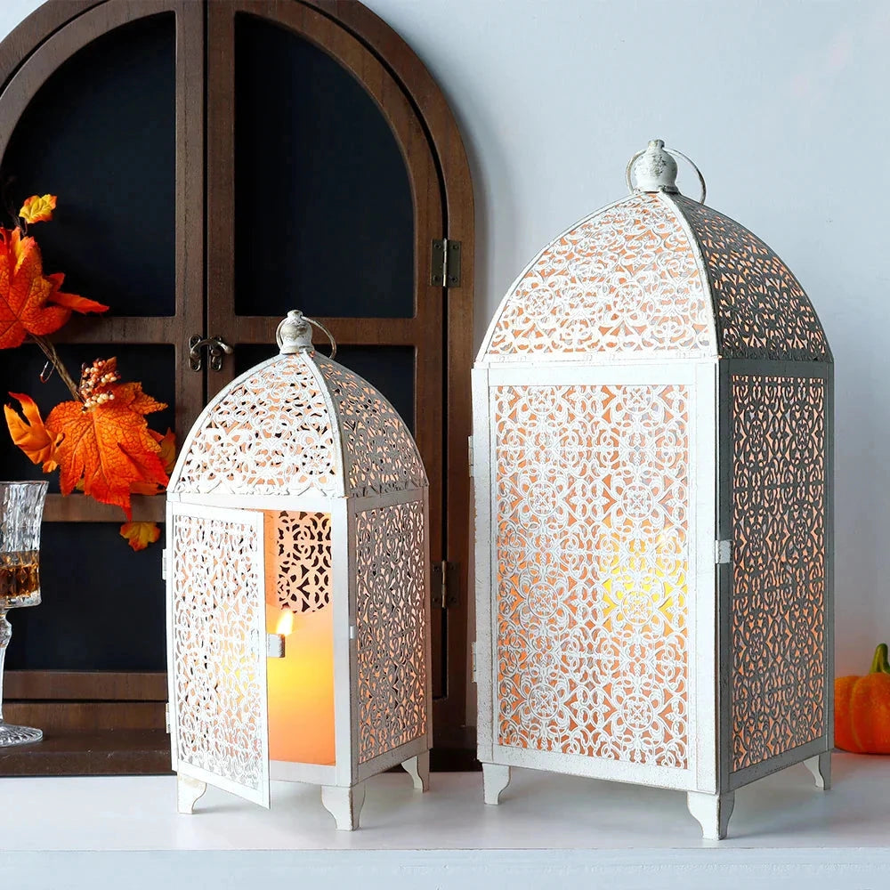 Set of 2 white gold metal candle lanterns for indoor and outdoor decor, featuring intricate architectural design with orange and yellow accents.