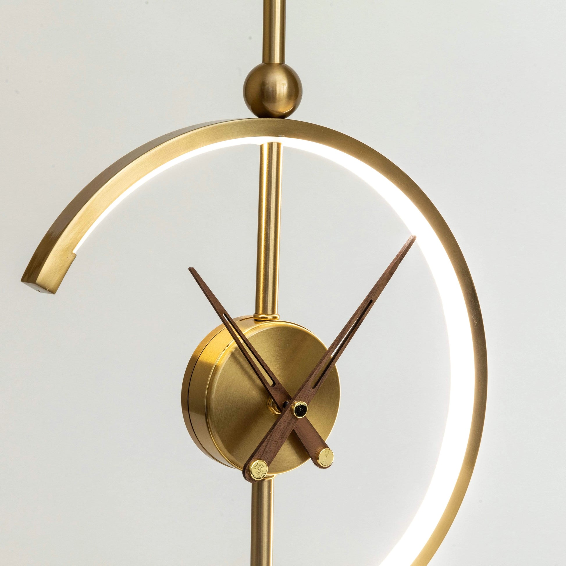 Modern wooden wireless charging clock lamp with integrated LED light, circular design, and digital clock display on a metal base.