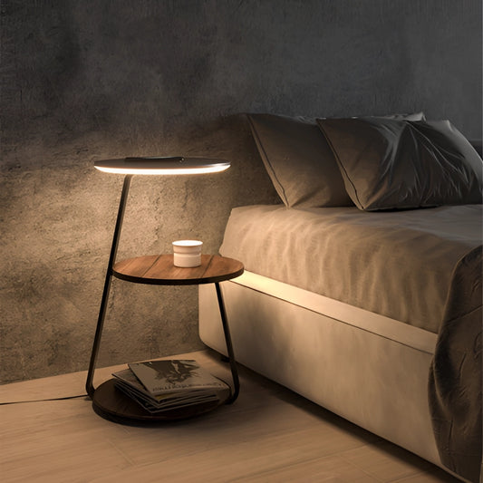 Wireless Charging Premium Desk in double walnut finish placed in a comfortable, well-lit living room with a modern couch and lamp, featuring wooden flooring and a rectangular design.