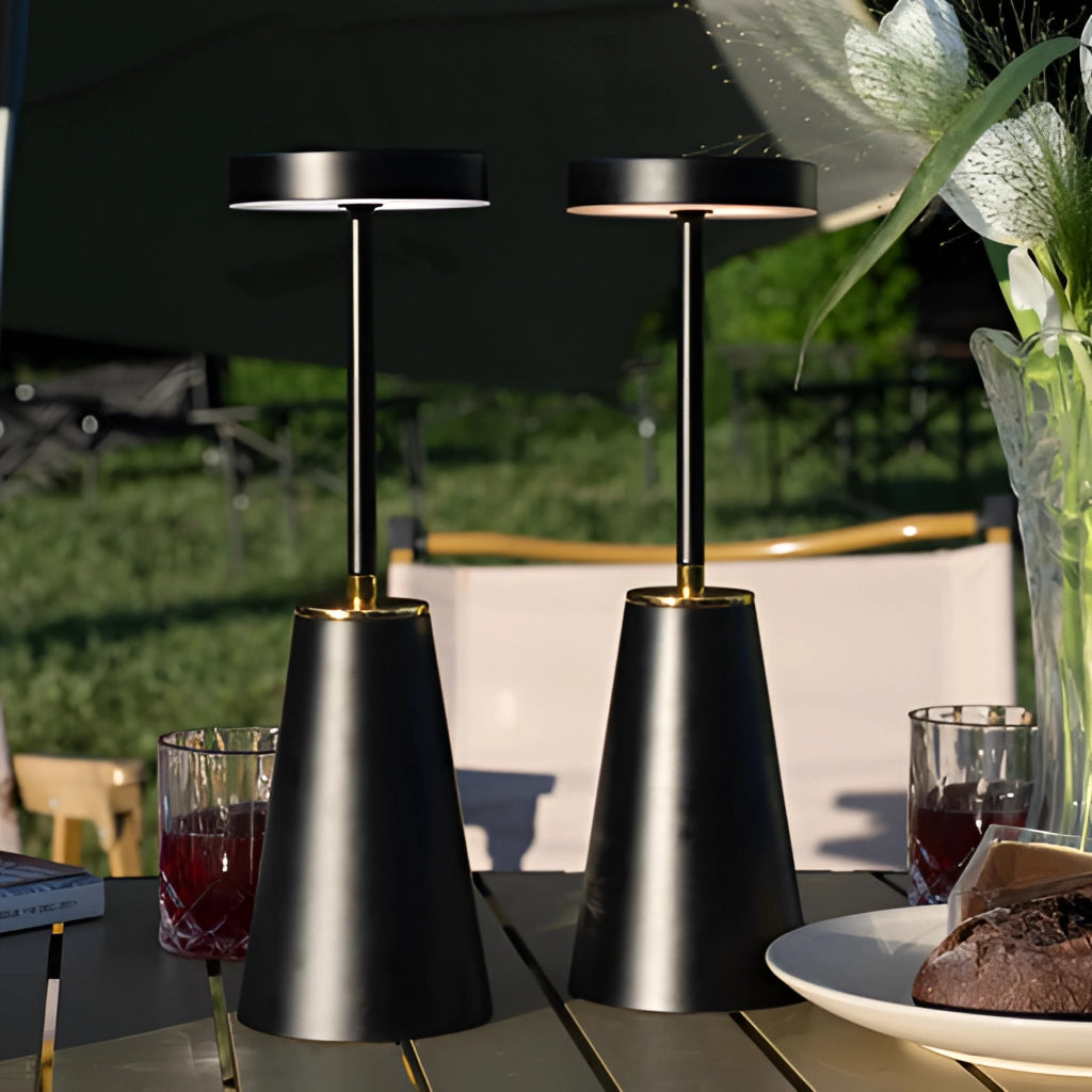 Wireless LED table lamp with touch technology on a table, surrounded by tableware, a plant, and drinkware, showcasing interior design.