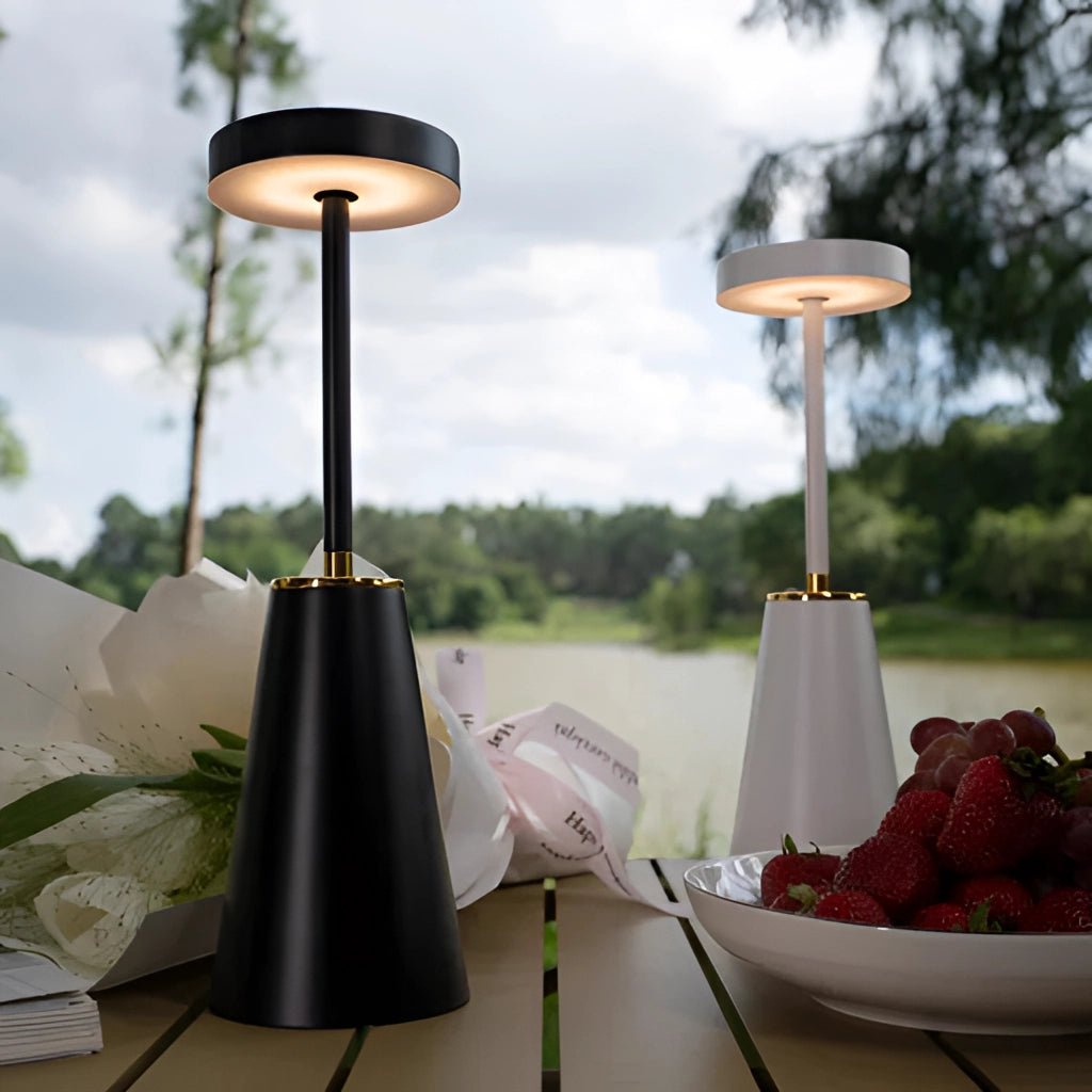 Wireless LED Table Lamp with Touch Technology on a wooden table, surrounded by interior elements like plants and fruits, with a cloudy sky visible in the background.