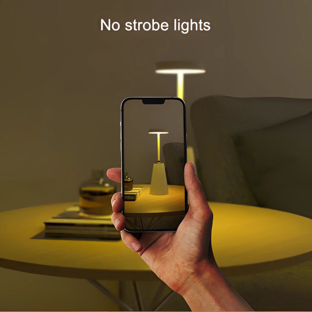 Wireless LED table lamp with touch technology on a modern living room table, featuring an aluminum alloy body and comfortable lighting ambiance.