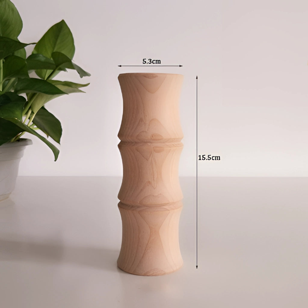 A wooden tall decor vase, labeled J007, holding a houseplant.