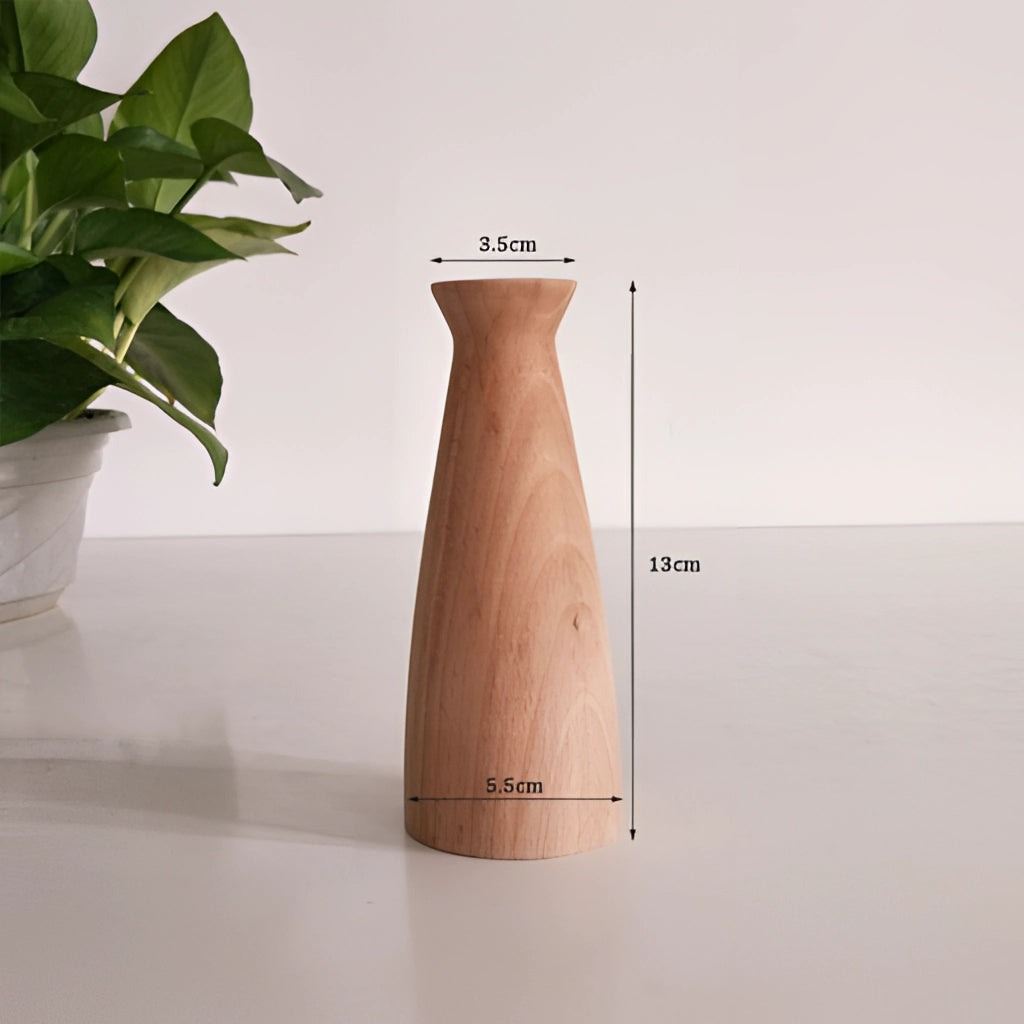 A tall wooden decor vase labeled J002, placed on a table, featuring a houseplant.
