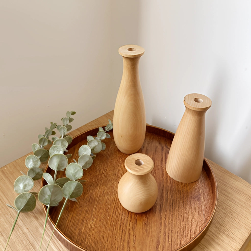 A tall, beige wooden decor vase placed on a table, showcasing its intricate hardwood design and wood stain finish.